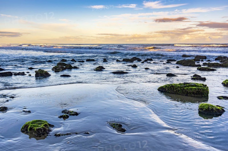 Quiet and deserted beach with rocks during sunset in the city of Torres in Rio Grande do Sul