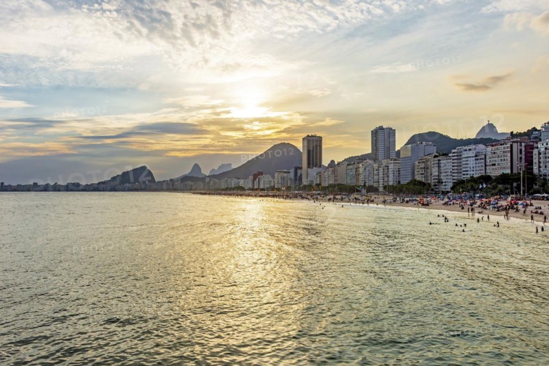 Sunset on the famous Copacabana beach with the sea