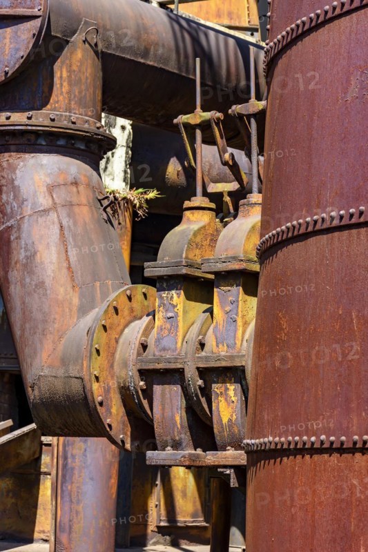 Corroded and rusty gears and piping from old machinery for processing iron ore in Minas Gerais