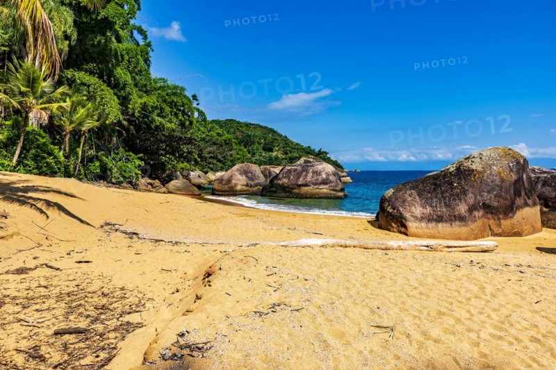 Paradisiacal and deserted beach with colorful waters surrounded by rainforest in Ilha Grande bay in Angra dos Reis on the coast of Rio de Janeiro