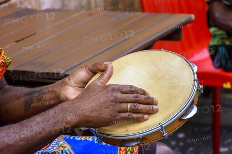 Brazilian samba performance with musician playing tambourine in the streets of Pelourinho
