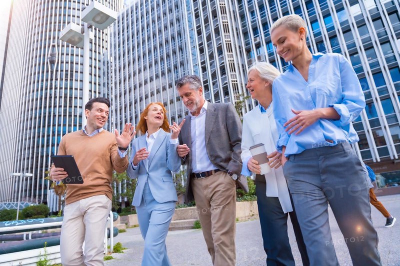 Group of coworkers walking going to work outdoors in a corporate office area
