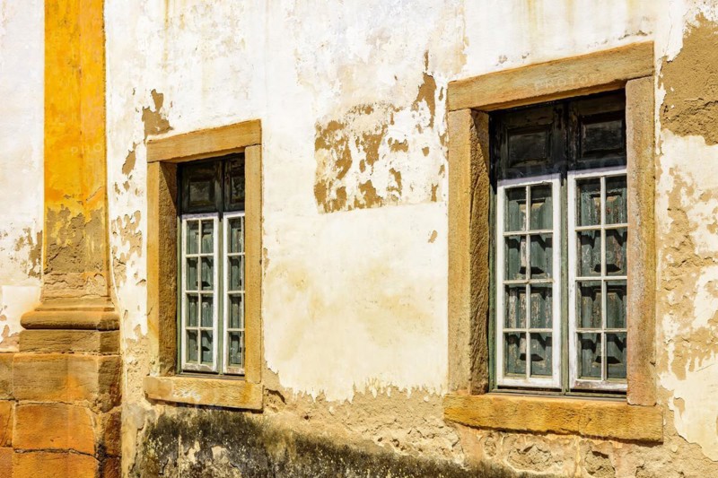 Historic church windows in colonial style with rustic stone frame in the ancient city of Ouro Preto in Minas Gerais