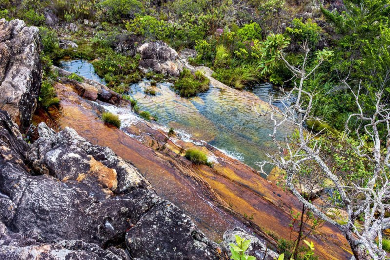 Top view of the cascade and water pools of the Biribiri environmental reserve in Diamantina in the state of Minas Gerais with its hills