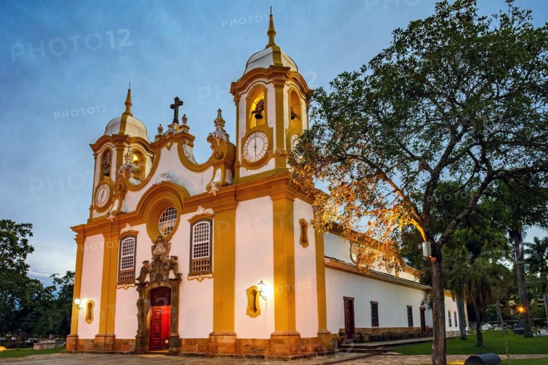 Historic church in the city of Tiradentes in Minas Gerais with its facade lit up at dusk