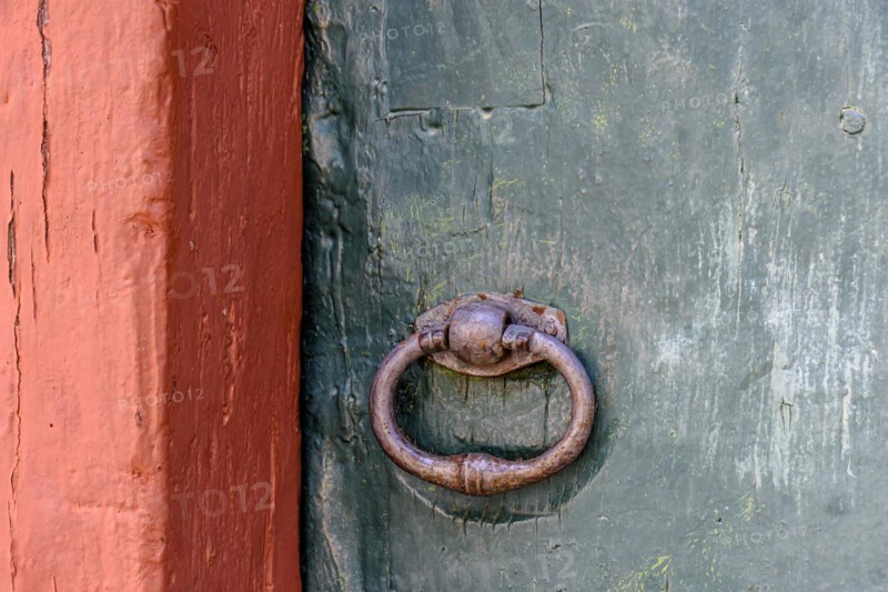 Detail of antique wooden colorful door and lock deteriorated by time and rust in a colonial style house in the historic city of Diamantina in Minas Gerais