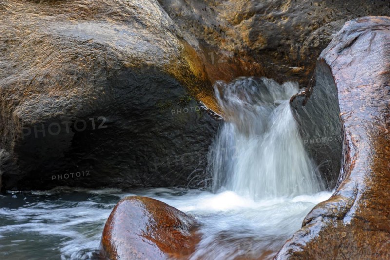 Small creek with clear waters running through the rocks of the mountains of Minas Gerais