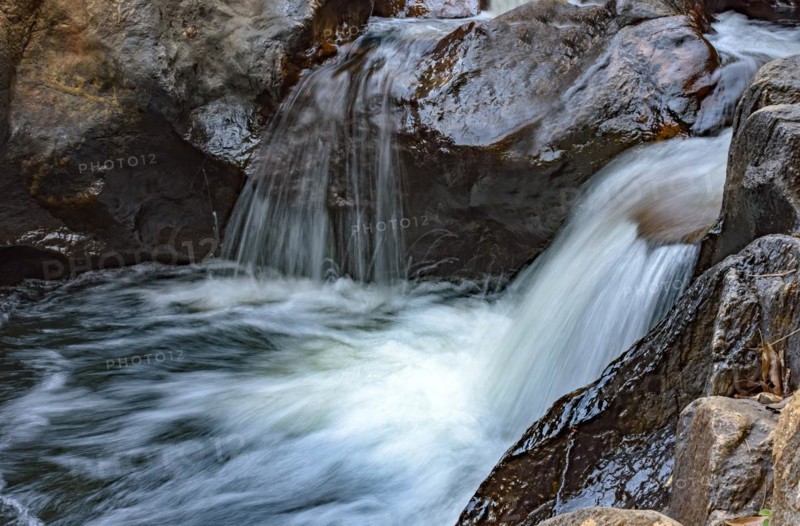 Small creek with clear waters and casacade running through the rocks of the mountains of Minas Gerais