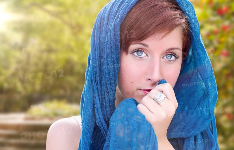 Pretty blue eyed young red haired adult female outdoor portrait