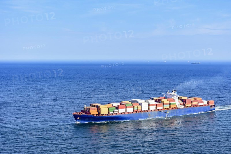 Cargo ship carrying several containers on the waters of the blue sea of rio de Janeiro