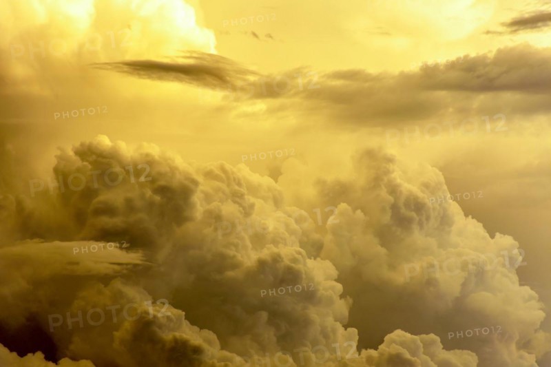 Large rain clouds in the sky illuminated by the sunset