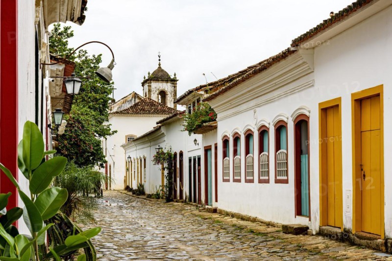 Cobblestone street in the historic center of Paraty with old church in the background