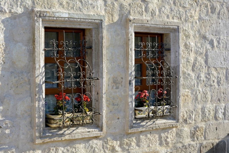 Window and red flowers in a house in the town of Goreme in Cappadocia