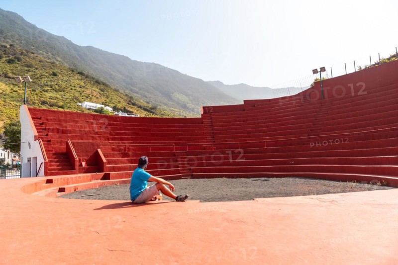 A tourist visiting the amphitheater next to the Nuestra Senora de Candelaria church in La Frontera on El Hierro