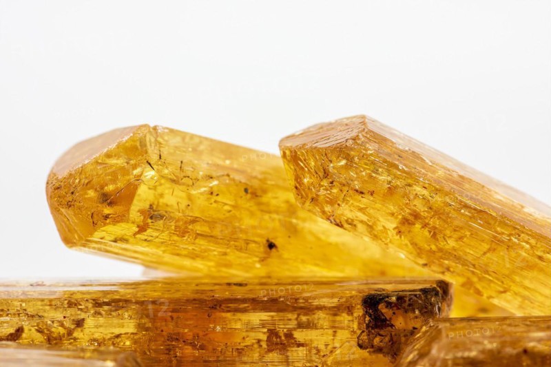 Studio photography of some Brazilian imperial topaz in raw state with white background