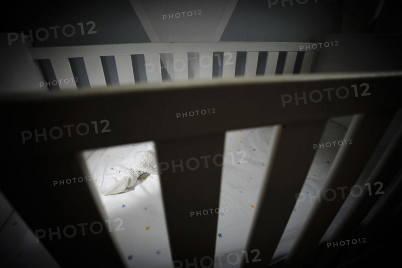 Symbolic photo on the subject of child abuse. A stuffed animal lies in an empty cot. Berlin
