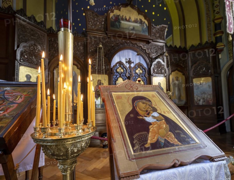 Burning candles next to an icon in the Russian Chapel