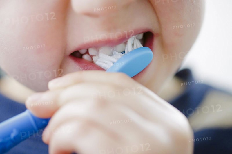 Symbolic photo on the subject of dental care for children. A boy brushes his teeth. Berlin