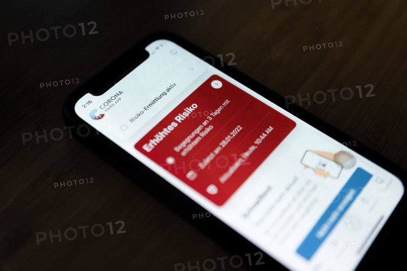 A red Corona Warn app indicates an increased risk of infection with Covid-19 coronavirus on an iPhone 12 Mini in Berlin