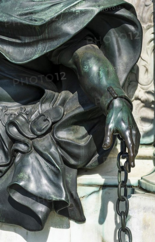 Detail photo of the chained warriors at the base of the equestrian statue of Frederick William of Brandenburg