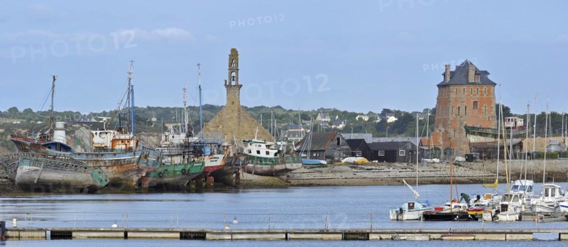 The fortification Tour Vauban and wrecks of small trawler fishing boats in the harbour of Camaret-sur-Mer