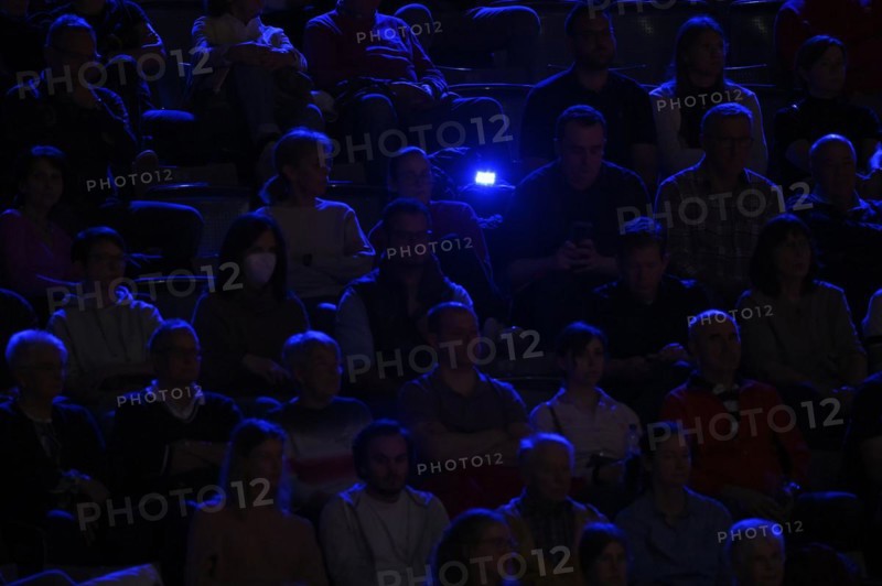 Spectators in blue light