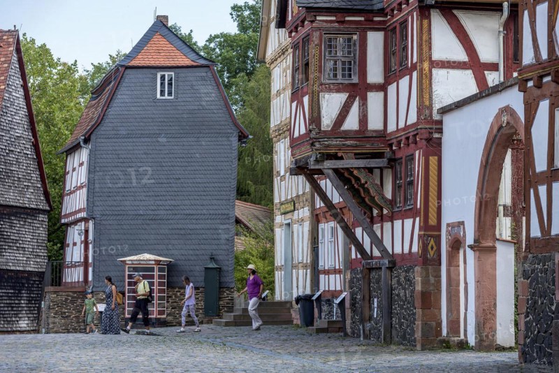People in a street with historic half-timbered houses