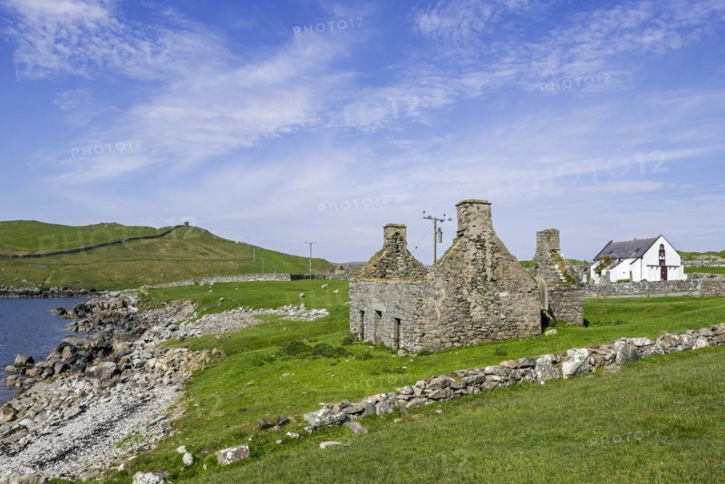 Ruin of old fishing booth and 18th century Lunna Kirk at East Lunna Voe
