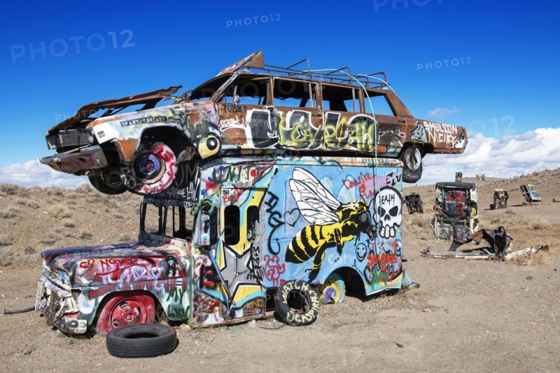 Cars sunk into the ground and sprayed with graffiti