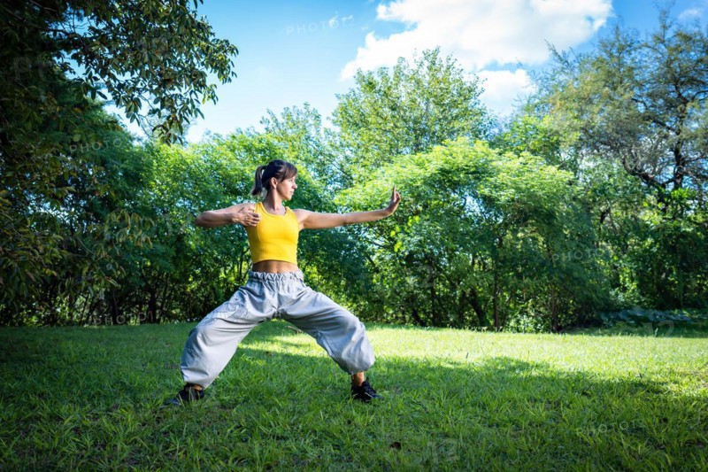 Woman practices Tai Chi outdoor
