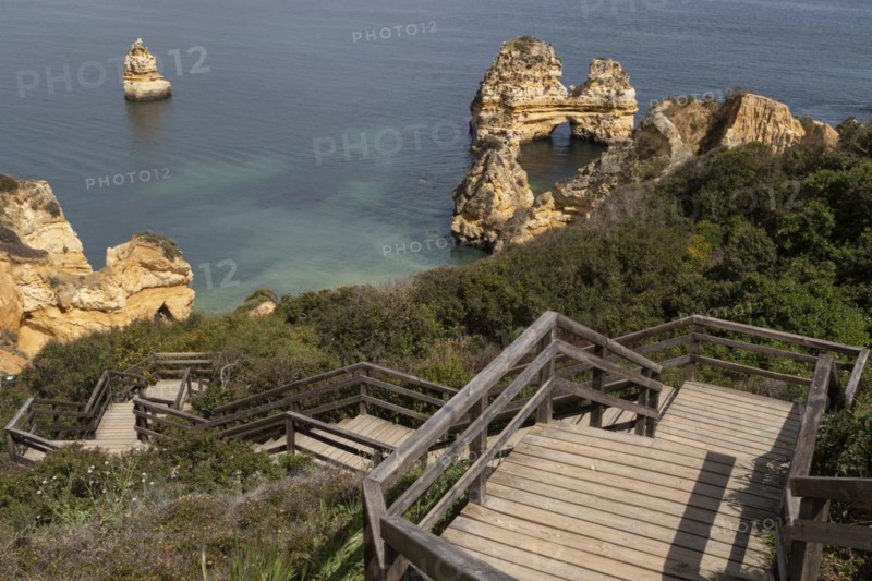 Wooden stairs and rock formation at Praia do Camilo on the coast of Lagos