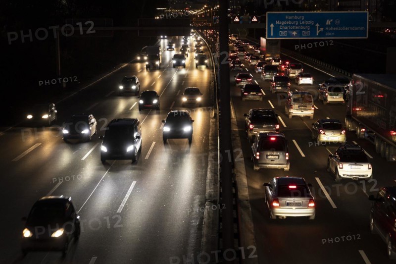 Congested traffic on the A100 looms at blue hour in Berlin