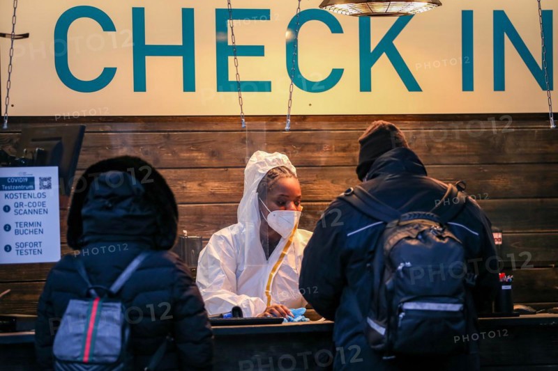 Two people are checked in by an employee of a COVID-19 test centre for a Corona test in the old town of Duesseldorf