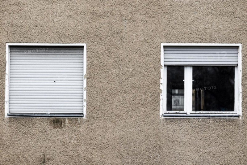 Lowered blinds stand out at an abandoned residential building in Berlin