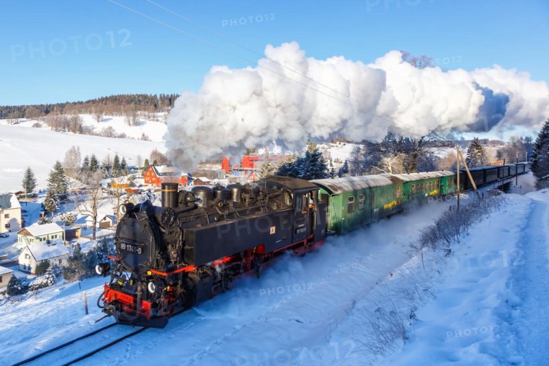 Steam train of the Fichtelbergbahn railway Steam locomotive in winter in Sehmatal