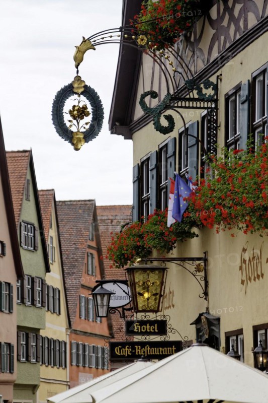 Late medieval townscape with hotel and nose sign