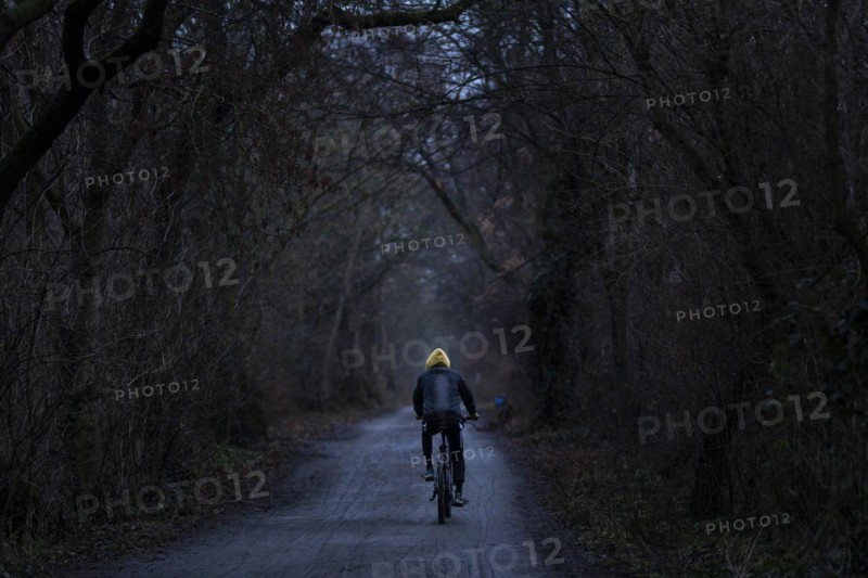 A man rides his bicycle along the Teltow Canal in Berlin