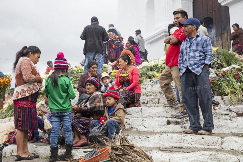 Local people called Mayan K'iche selling flowers on market day in front of the church Iglesia de Santo Tomas in Chichicastenango