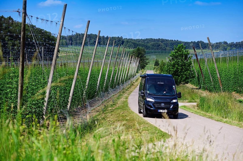 Motorhome driving through hop-growing area in the Hallertau