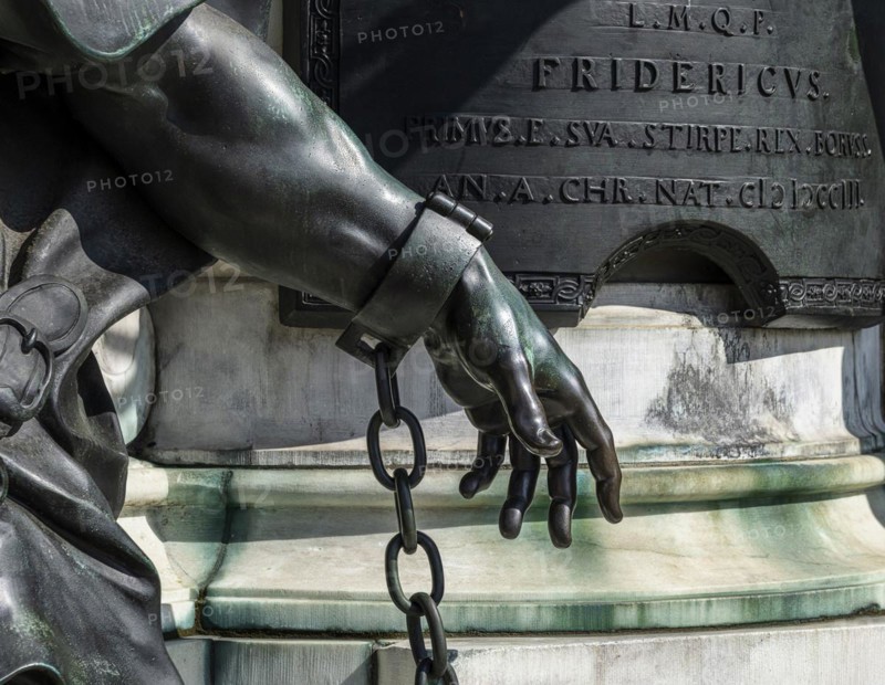 Detail photo of the chained warriors at the base of the equestrian statue of Frederick William of Brandenburg