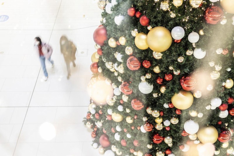 People stand out against Christmas decorations in a shopping centre on Schlossstrasse in Berlin