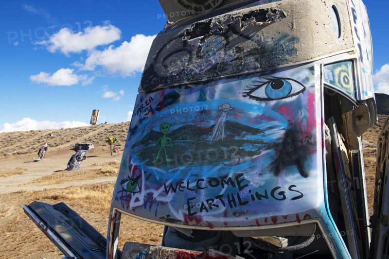 Cars sunk into the ground and sprayed with graffiti