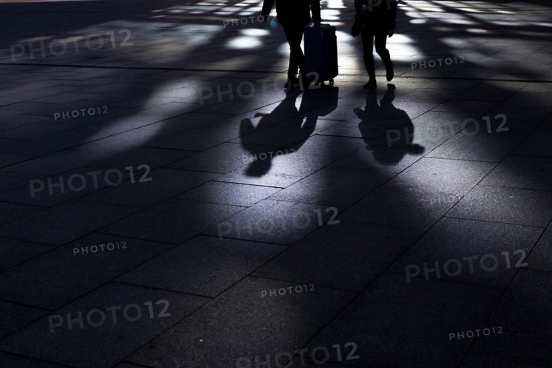The silhouette of travellers stand out in front of the main station in Berlin