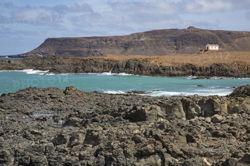 Praia de Fatima and abandoned chapel of Our Lady of Fatima looking over the rugged coast and cliffs near Sal Rei on the island Boa Vista