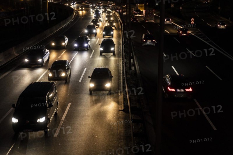 Congested traffic on the A100 looms at blue hour in Berlin