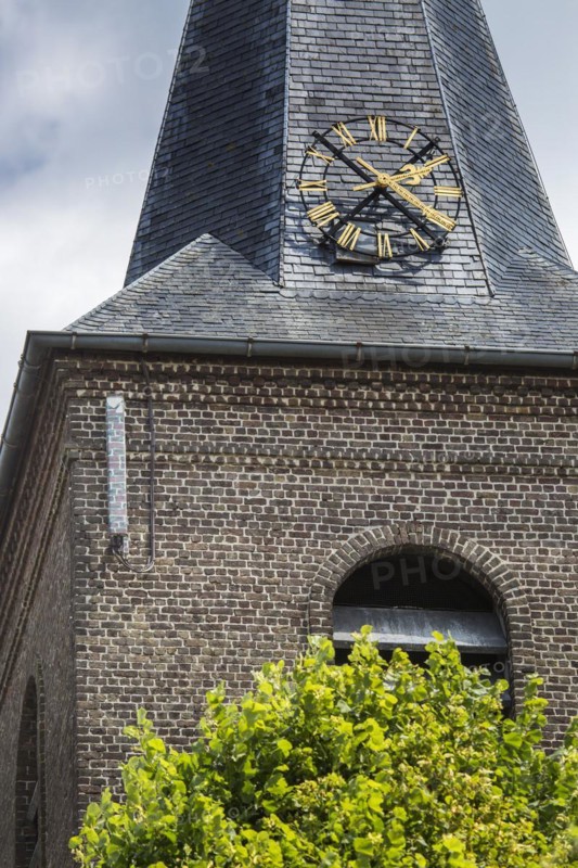 Camouflaged antenna showing brick pattern from base station for mobile telephony on church tower