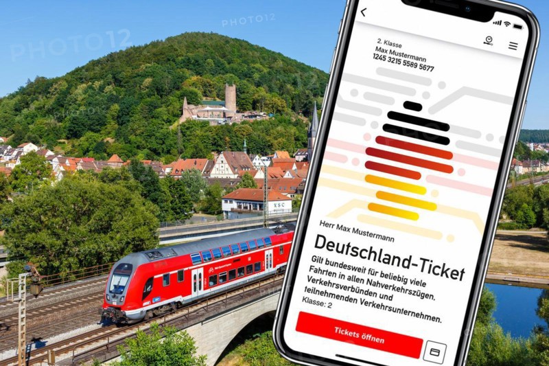 Deutschland-Ticket D-Ticket or 49 euro ticket on a mobile phone with a regional train of Deutsche Bahn DB Photomontage in Gemuenden am Main