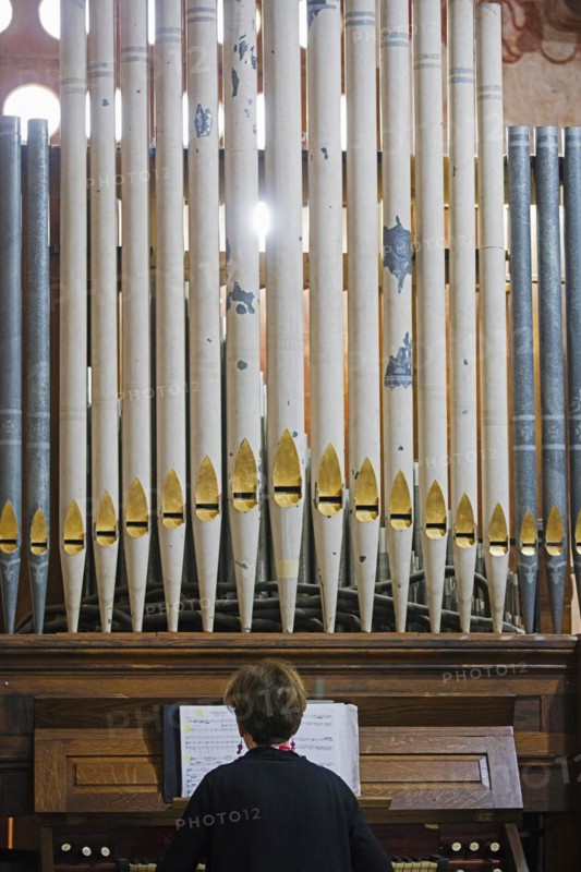 Organist playing Baroque pipe organ in the Jesuit Mission church of San Jose de Chiquitos