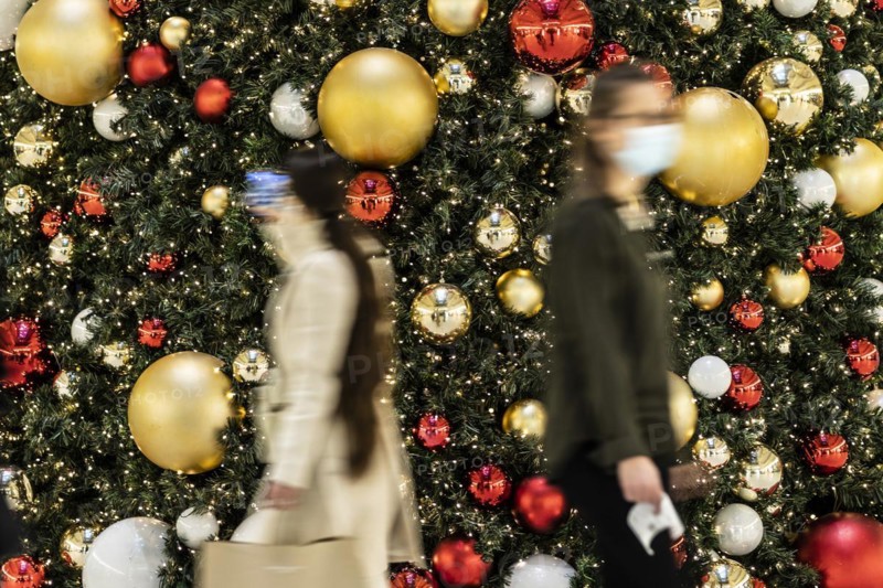 People stand out against Christmas decorations in a shopping centre on Schlossstrasse in Berlin