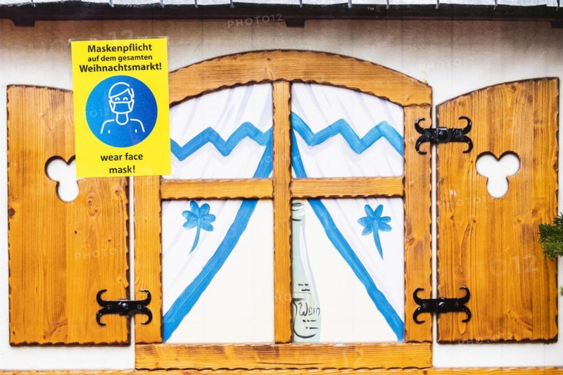 A sign indicating that masks are compulsory stands out at the Christmas market on Alexanderplatz in Berlin